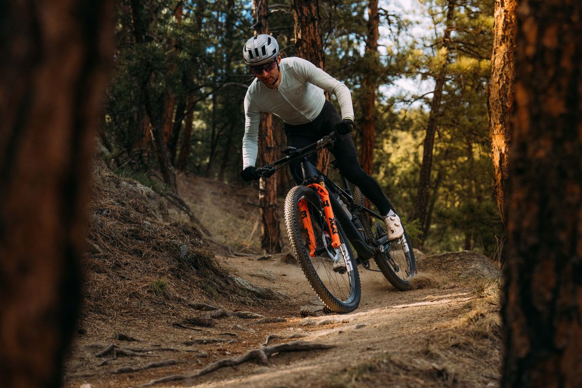 Rider ripping a berm in the forest on Kenda Dagger tires