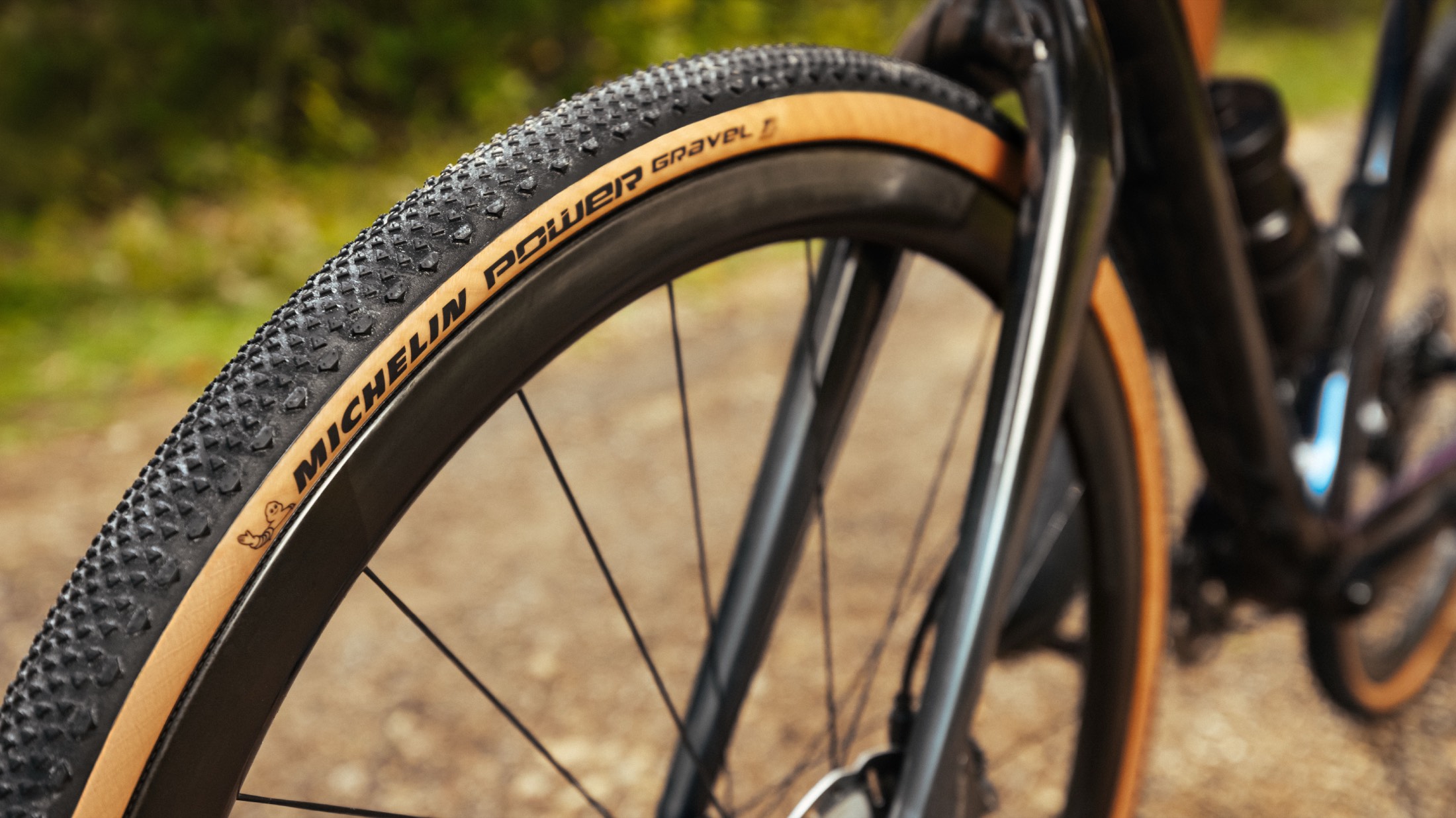 Close-up of the Michelin Power Gravel Competition tire, Black/Tan, mounted on a gravel bike wheel